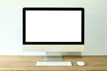 Isolated LCD monitor of iMac computer on white background with blank screen on wooden table