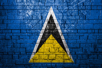 National flag of Saint Lucia on brick  wall background.The concept of national pride and symbol of...