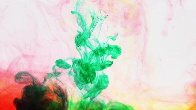green paint is poured into a multicolored mixture ink paint in water, relax background