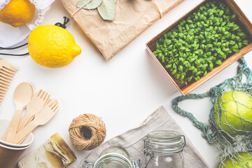 Zero waste concept. Eco-friendly kitchen and bath set. Brushes, soap, textile bags, glass jars, wooden cutlery and plant, top view copy space