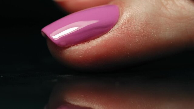 manicurist applying purple nail polish. manicure process. Application of nail polish on nails.