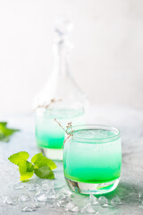 glass of cold drink with fresh mint leaves and ice cubes