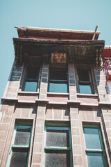 Fototapeta na wymiar old building with windows from below