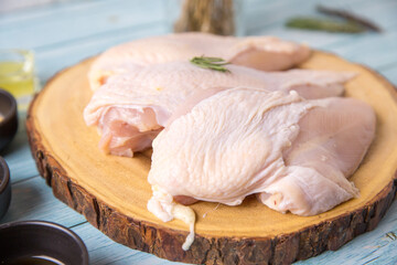 Raw chicken, on a wooden board, meat containing ingredients for cooking