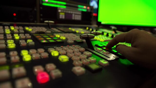 Broadcast Tv Studio Production - Vision Switcher 
Studio Director broadcast video mixer operation - Close-up of hand