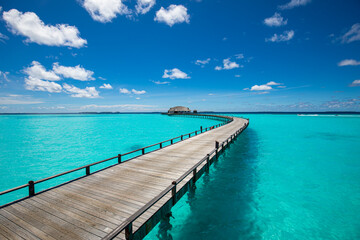 Obraz premium Tropical landscape of Maldives beach. Seascape panorama, luxury water villa resort with wooden pier or jetty. Luxury travel destination background for summer holiday and vacation concept.