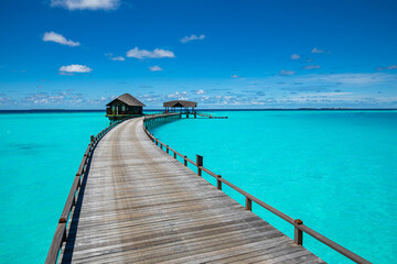 Fototapeta na wymiar Tropical landscape of Maldives beach. Seascape panorama, luxury water villa resort with wooden pier or jetty. Luxury travel destination background for summer holiday and vacation concept.