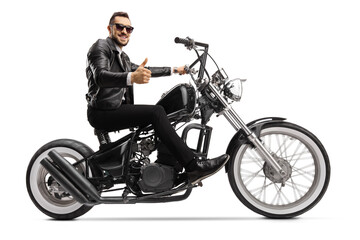 Fototapeta na wymiar Biker on a custom chopper riding and showing thumbs up