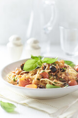 Spaghetti Pasta with Vegetables and fresh Basil on bright wooden Backgrounbd. 