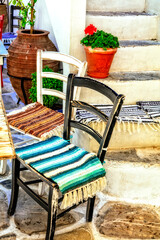 Traditional Greece. Typical street taverns (bars) with cute wooden chairs.  Greece. Naxos island, Cycades.