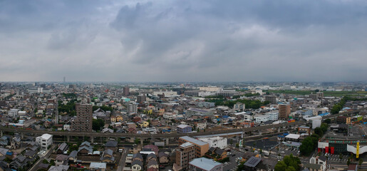 Fototapeta na wymiar 航空撮影した夏の名古屋の街並みと曇りの空