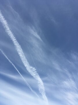 White Vapour Trails In A Blue Sky