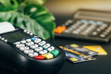 Credit card reader machine or Payment terminal with credit card on table