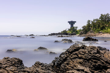 Fototapeta na wymiar Beautiful costline with waves and granite rocks background blue sky,long exposure. 