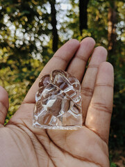 hand holding a glass figurine.