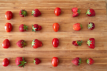 Strawberries and sweet tomatoes in a row