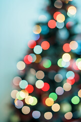 Christmas and New Year interior - blur background:  green Christmas tree.  Lots of lights glowing .Bokeh