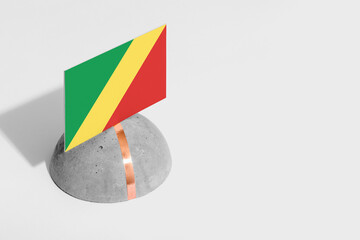 Republic Of The Congo flag tagged on rounded stone. White isolated background. Side view minimal national concept.