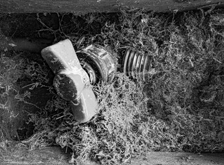 Black and white close up picture of a water valve covered in dust.