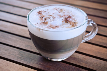 Cappuccino in transparent cup with copy space