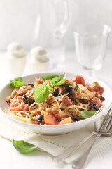 Spaghetti Pasta with Vegetables and fresh Basil on bright wooden Backgrounbd.
