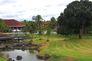 Obraz premium Conference hall facade surrounded with lake, trees, and golf course at Mount Malarayat in Lipa, Batangas, Philippines