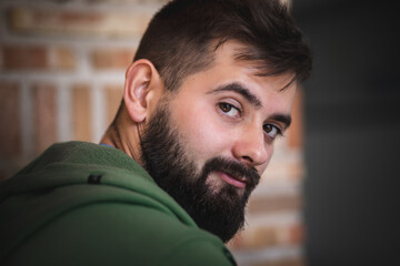 Obraz premium beautiful portrait of Handsome young man with beard looking at the camera from a close view