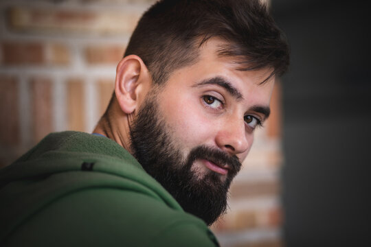 beautiful portrait of Handsome young man with beard looking at the camera from a close view