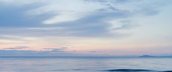 beautiful clouds over the sea. seascape, natural minimalistic background and texture, panoramic view banner. pastels tones