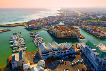 Fototapeta premium Aerial view of a protected marina with boats near Strand, South Africa