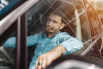 Successful male businessman driving a car