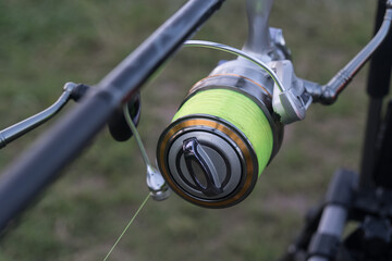 Fishing rods closeup. Carp reels on a stand in a pond