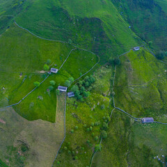 Spring landscape of mountains, meadows of mowing and cabins pasiegas near La Concha, in the Valle...