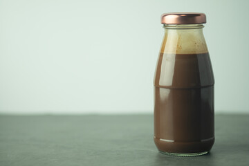 Milk cocoa in glass bottle.