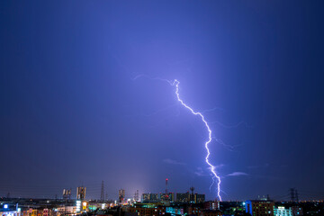 thunder storm lighting bolts in blue  sky splitting and hit the sky twice