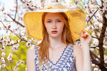 Close up portrait of a young girl with a straw hat
