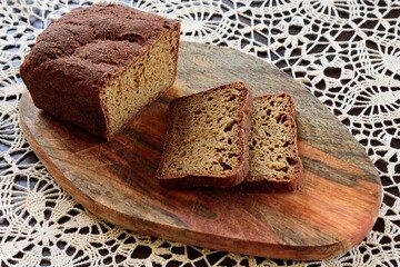 View of slices rye of bread on hand knitted tablecloth background