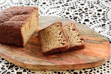 View of slices rye of bread on hand knitted tablecloth background