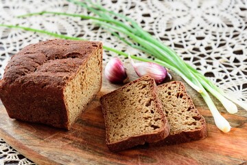 View of slices rye of bread on hand knitted tablecloth background