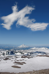 The cloud over Vilyuchinsky volcano shaped like a giant dragon, view from the slope of Gorely volcano, Kamchatka Peninsula, Far East Russia. Huge cloud that looks like a dragon