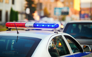 Blue and red light flasher on top of police car. Flashing lights of police car, stopping the...