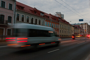 Motion blurred minibus on the street at dusk.