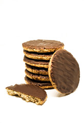 Chocolate coated whole wheat biscuits with added vitamins. Rounded cookies on white background isolated