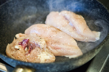 Sausage stuffed chicken breast fried in a pan