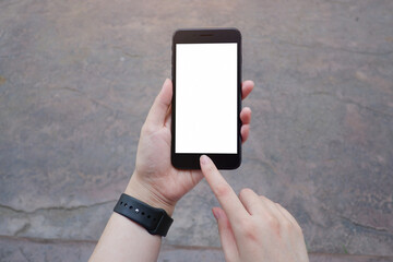 Cropped shot view of business woman’s hands holding the mobile phone with blank copy space screen for your information content or text message.