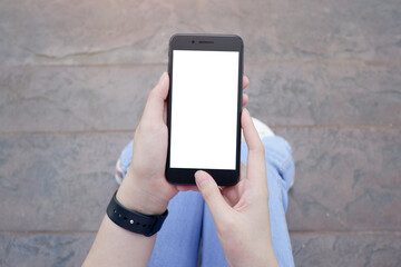 Cropped shot view of business woman’s hands holding the mobile phone with blank copy space screen for your information content or text message.