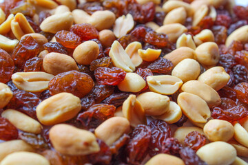 Background texture of mixed,healthy peanuts and raisins.