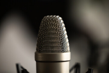 Closeup of condenser microphone for narration, podcasting, singing, recording or voiceovers. 