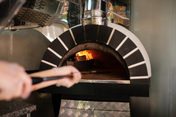 Italian pizza wood stove. Italian pizza is cooked in a wood-fired oven.