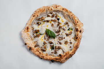 Italian pizza with mushrooms, cheese and olive oil on a white background.